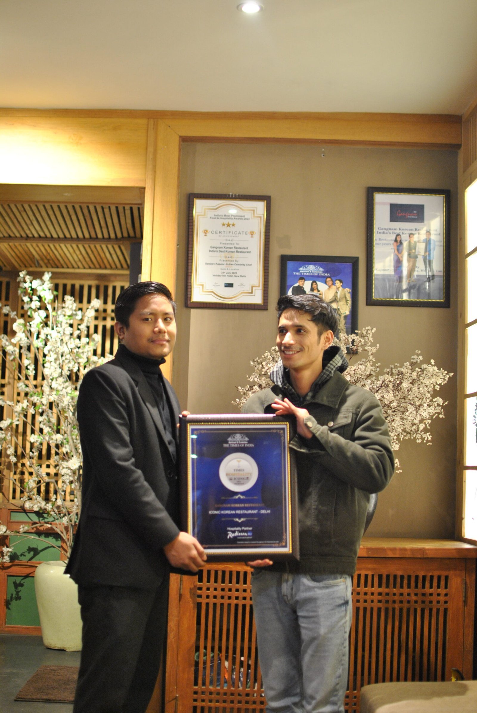 Gangnam team holding the Times Hospitality Icons award
